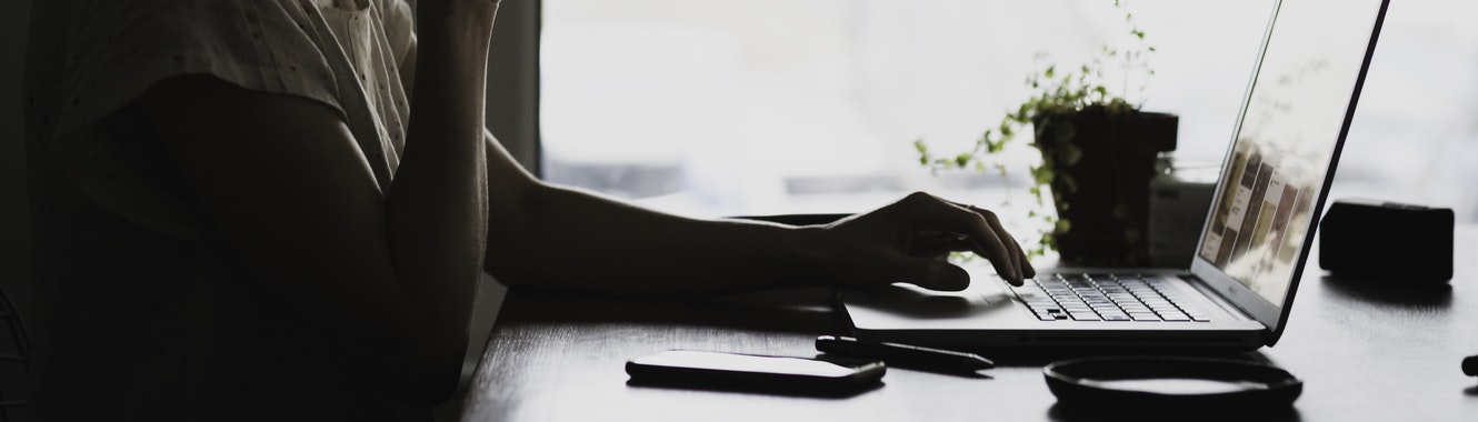 Woman typing on her laptop.